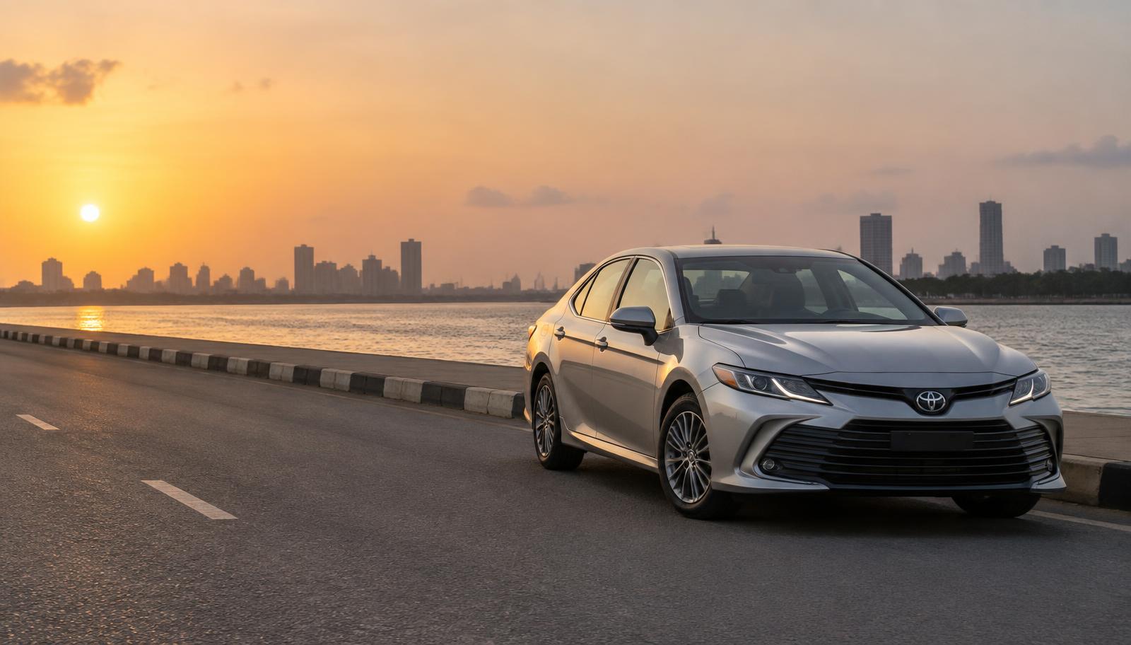 Silver Toyota Camry on a Lagos waterfront road at sunset